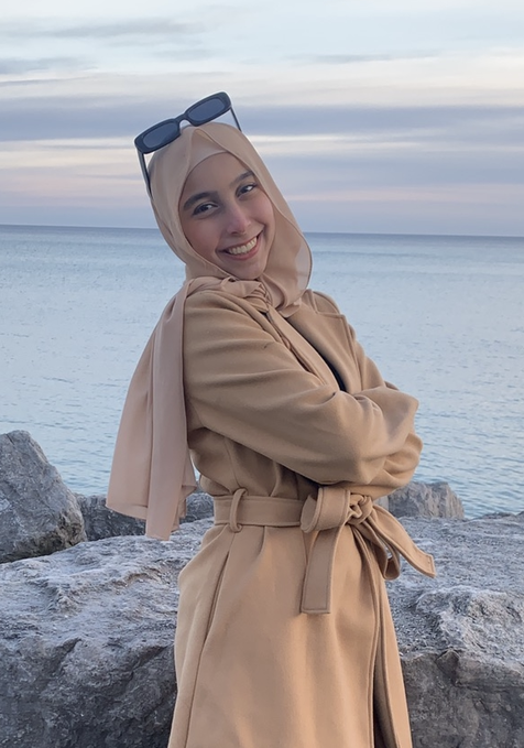 a young woman in front of the sea