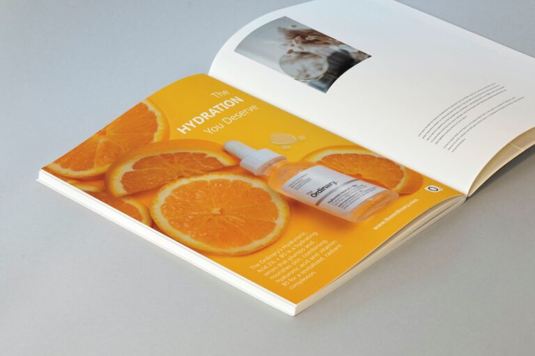 the inside of a magazine about the ordinary hyaluronic acid product. the product is surrounded by oranges on an orange background.
