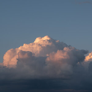 a big cloud that is pink, purple, and yellow.